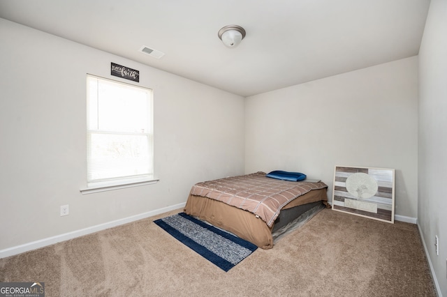 bedroom featuring visible vents, baseboards, and carpet floors