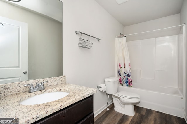 full bath featuring baseboards, toilet, shower / tub combo with curtain, wood finished floors, and vanity