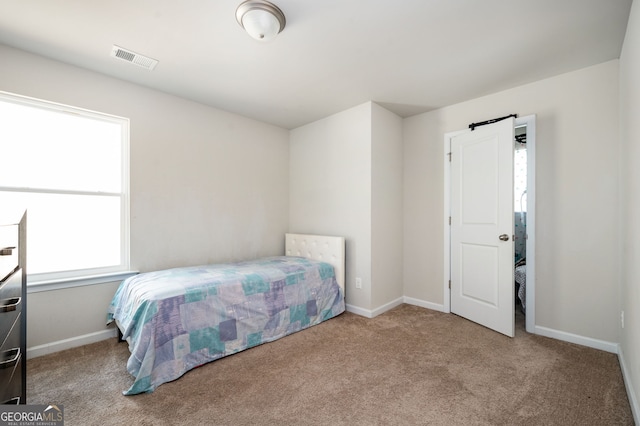 carpeted bedroom with visible vents and baseboards