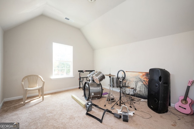 exercise area featuring visible vents, lofted ceiling, baseboards, and carpet flooring