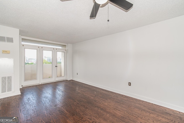 empty room with dark wood-style floors, visible vents, a textured ceiling, and ceiling fan