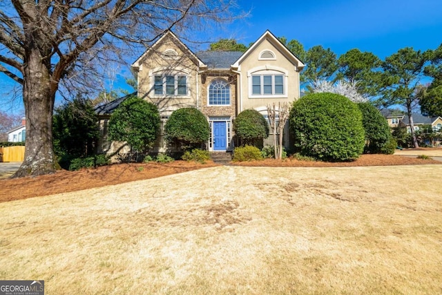 view of front of house with a front lawn and stucco siding