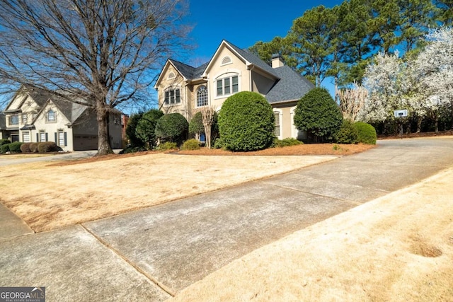 view of front of property featuring stucco siding and a chimney