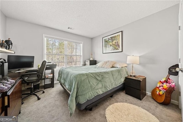 bedroom featuring baseboards, visible vents, carpet floors, and a textured ceiling