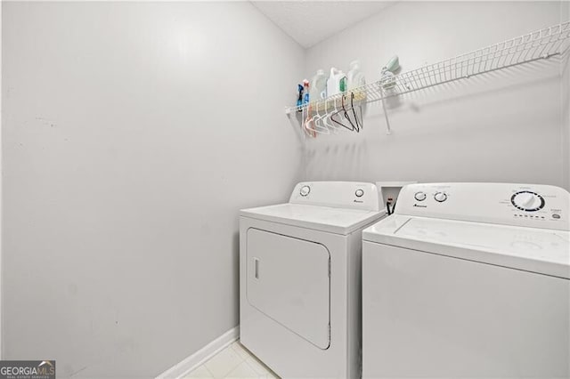 laundry room featuring baseboards, laundry area, and washer and clothes dryer