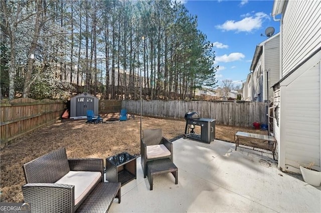 view of patio / terrace featuring an outbuilding, a storage unit, and a fenced backyard