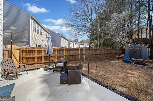 view of patio featuring a storage shed, a fenced backyard, and an outdoor structure