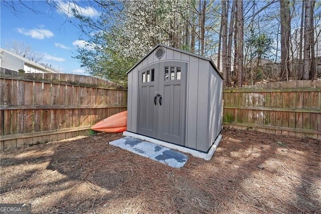 view of shed with a fenced backyard