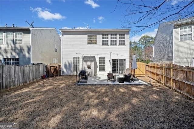 back of property featuring a gate, a patio area, and a fenced backyard