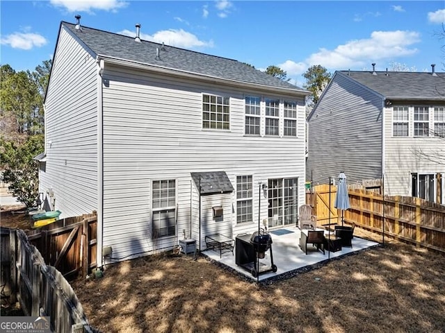 back of house featuring a patio and a fenced backyard