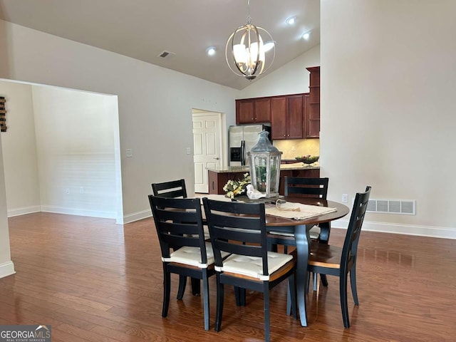 dining room featuring a notable chandelier, dark wood-style floors, visible vents, and baseboards