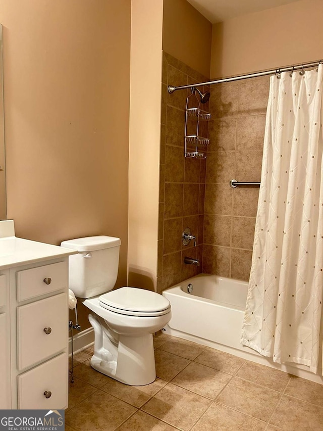 full bathroom featuring tile patterned flooring, toilet, shower / bath combo with shower curtain, and vanity