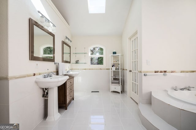 full bath with tile patterned flooring, tile walls, and a garden tub