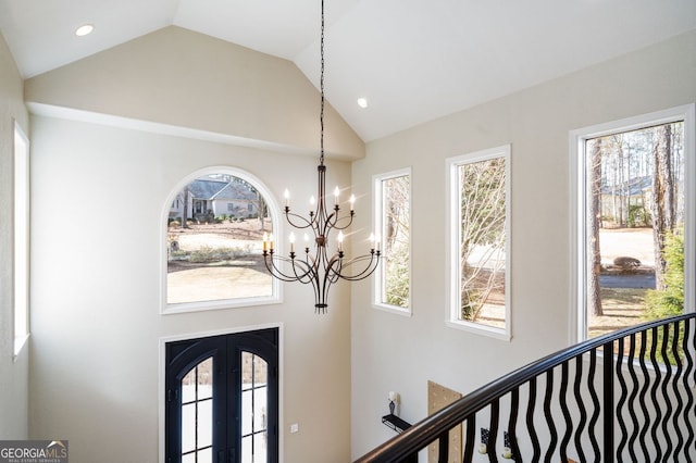 foyer featuring recessed lighting, french doors, and high vaulted ceiling