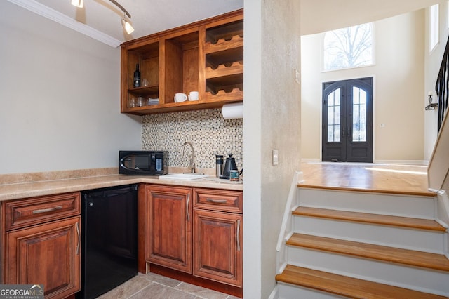 kitchen featuring a sink, backsplash, fridge, french doors, and black microwave