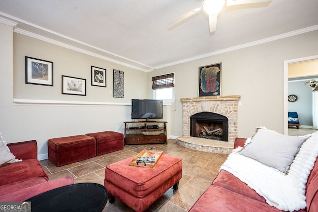 living room with baseboards, a ceiling fan, ornamental molding, and a fireplace