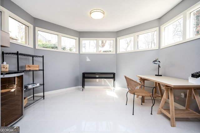 home office featuring wine cooler and baseboards