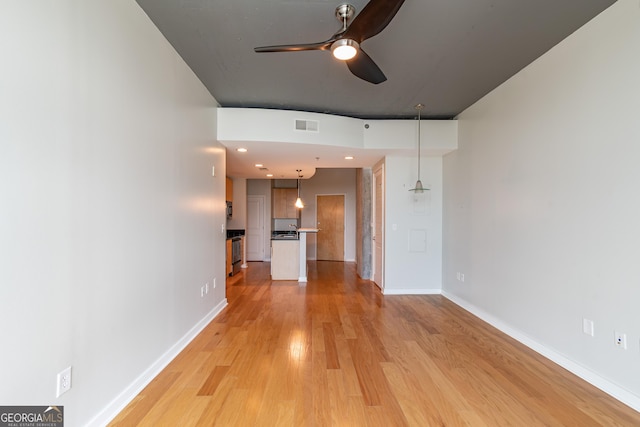 361 17th St Unit 1516, Atlanta, GA 30363 - unfurnished living room featuring a ceiling fan and light wood-style floors