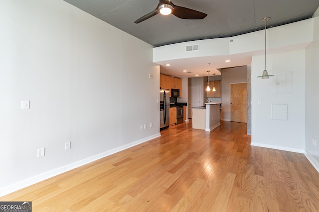 361 17th St Unit 1516, Atlanta, GA 30363 - unfurnished living room with ceiling fan and light wood-style flooring