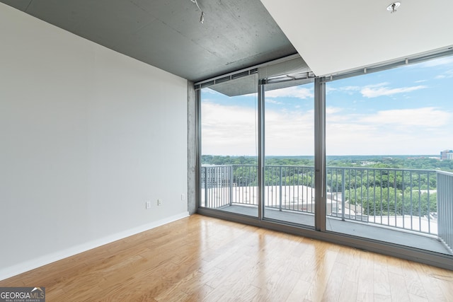 361 17th St Unit 1516, Atlanta, GA 30363 - spare room with wood finished floors and floor to ceiling windows