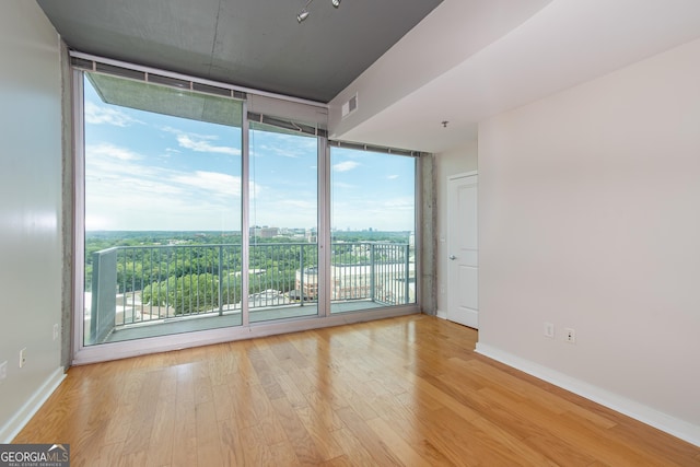 361 17th St Unit 1516, Atlanta, GA 30363 - spare room with a wall of windows and wood finished floors
