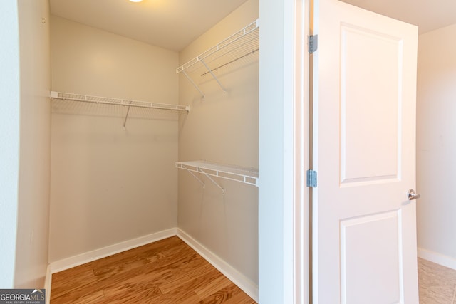361 17th St Unit 1516, Atlanta, GA 30363 - walk in closet featuring wood finished floors