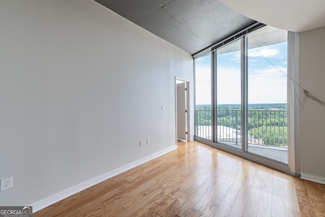 361 17th St Unit 1516, Atlanta, GA 30363 - unfurnished room featuring floor to ceiling windows and light wood-style flooring