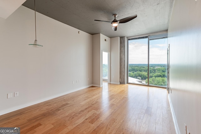 361 17th St Unit 1516, Atlanta, GA 30363 - spare room featuring floor to ceiling windows, light wood finished floors, and a ceiling fan