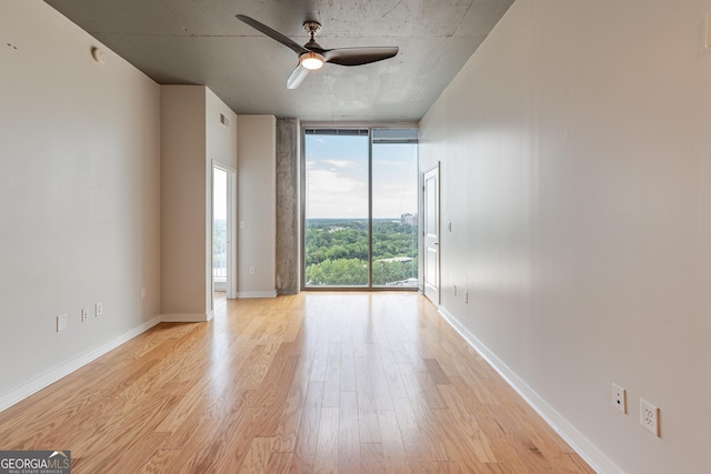 361 17th St Unit 1516, Atlanta, GA 30363 - unfurnished room featuring floor to ceiling windows, light wood finished floors, and a ceiling fan