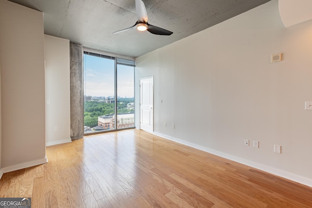 361 17th St Unit 1516, Atlanta, GA 30363 - empty room featuring floor to ceiling windows, light wood finished floors, and ceiling fan