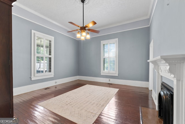 interior space featuring a fireplace, baseboards, wood-type flooring, and ornamental molding