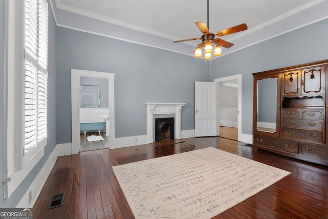 bedroom featuring visible vents, dark wood-type flooring, a fireplace, and crown molding