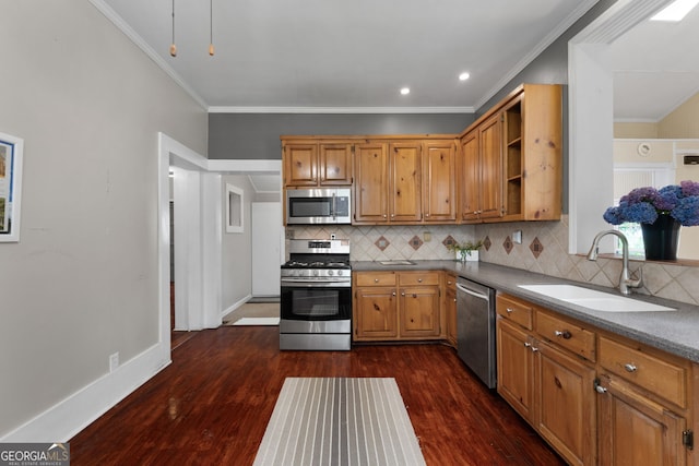 kitchen with tasteful backsplash, a sink, brown cabinetry, stainless steel appliances, and dark wood-style flooring