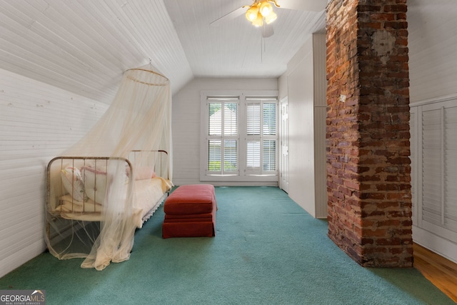 living area featuring vaulted ceiling, a ceiling fan, and carpet floors