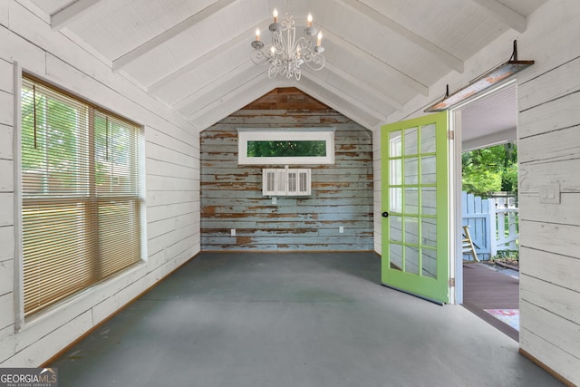 unfurnished sunroom featuring lofted ceiling with beams and a notable chandelier