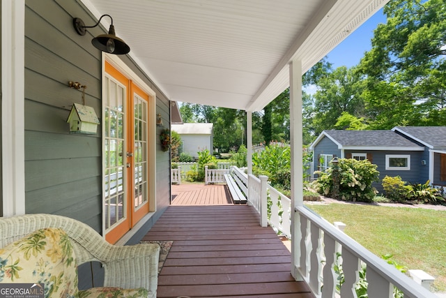 wooden deck featuring french doors and a lawn