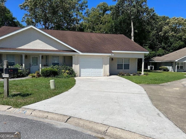 ranch-style home featuring a shingled roof, a front lawn, concrete driveway, stucco siding, and a garage