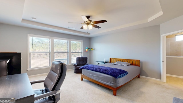 bedroom with visible vents, baseboards, a tray ceiling, and carpet floors