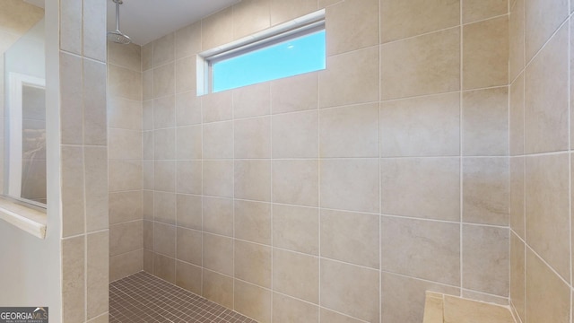 full bath featuring a tile shower