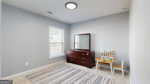 bedroom with visible vents, baseboards, and light colored carpet