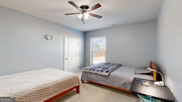 bedroom with a ceiling fan, light colored carpet, and visible vents