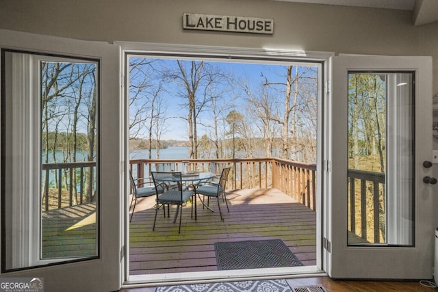 doorway featuring a water view and wood finished floors