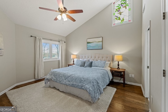 bedroom with baseboards, high vaulted ceiling, wood finished floors, and a ceiling fan