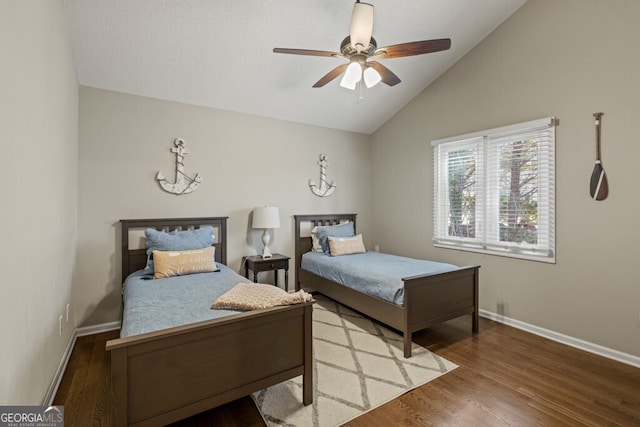 bedroom featuring a ceiling fan, lofted ceiling, wood finished floors, and baseboards