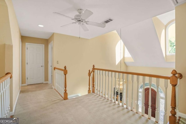 hallway with recessed lighting, visible vents, baseboards, and carpet