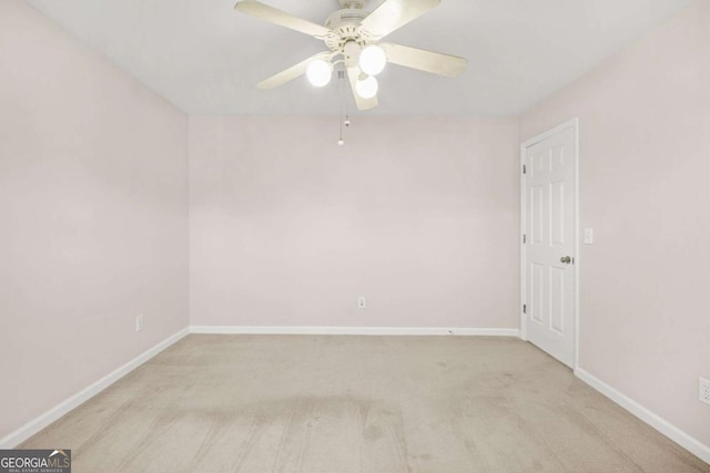 unfurnished room featuring baseboards, carpet, and a ceiling fan