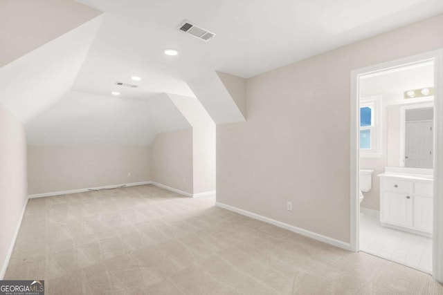 bonus room featuring visible vents, baseboards, recessed lighting, vaulted ceiling, and light colored carpet