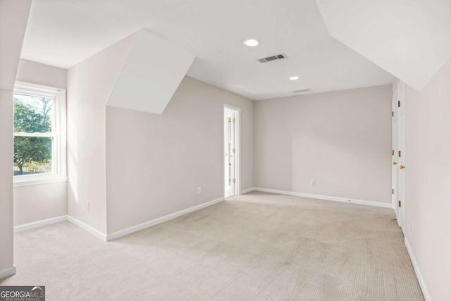 interior space featuring recessed lighting, visible vents, baseboards, and light colored carpet