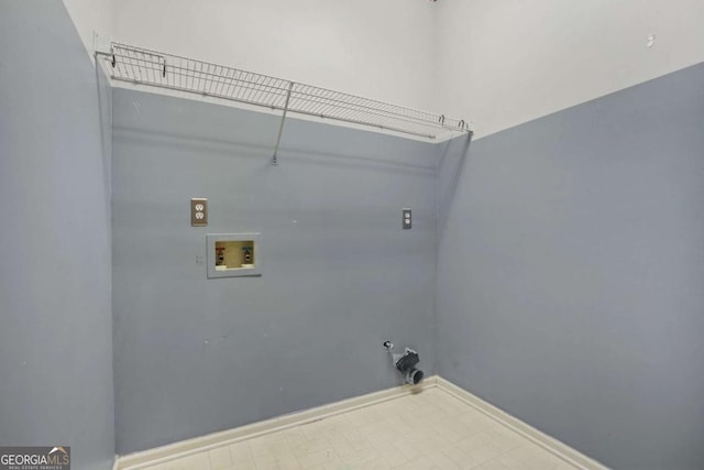 clothes washing area featuring baseboards, gas dryer hookup, washer hookup, laundry area, and tile patterned floors