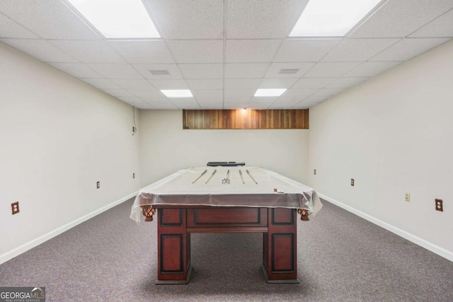 recreation room with a drop ceiling, baseboards, and dark colored carpet